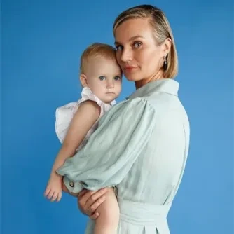 Erin Remblance holding her daughter, aged one